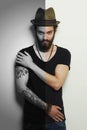 Handsome man in hat.Brutal bearded boy with tattoo Royalty Free Stock Photo
