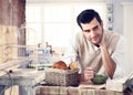 Handsome man having breakfast in cottage interior Royalty Free Stock Photo