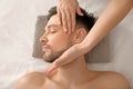 Handsome man having facial massage in spa salon Royalty Free Stock Photo
