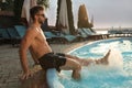 Handsome man having fun near outdoor swimming pool on sunny summer day Royalty Free Stock Photo