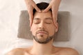 Handsome man having head massage in spa salon Royalty Free Stock Photo
