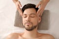 Handsome man having head massage in spa salon Royalty Free Stock Photo