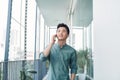 Handsome man having serious conversation on cell phone outside on balcony Royalty Free Stock Photo