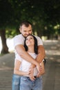 Handsome man with his gorgeous girlfriend. Happy couple walking along the embabkment. Green background