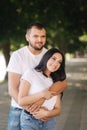 Handsome man with his gorgeous girlfriend. Happy couple walking along the embabkment. Green background