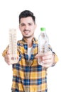 Handsome man holding a bottle of water and a thermometer Royalty Free Stock Photo