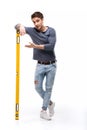 Handsome man holding building level isolated on white Royalty Free Stock Photo