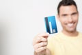 Handsome man holding debit card