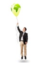 Handsome man holding a green globe balloon Royalty Free Stock Photo