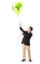 Handsome man holding a green globe balloon Royalty Free Stock Photo