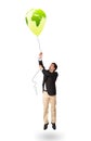 Handsome man holding a green globe balloon Royalty Free Stock Photo