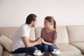 Handsome man holding hands of beautiful woman sitting indoors, p Royalty Free Stock Photo