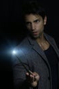 Handsome man holding a magic wand Royalty Free Stock Photo