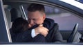 Handsome man hugging loving woman in car, romantic date, sweetness in relations