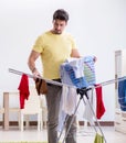 Handsome man husband doing laundering at home Royalty Free Stock Photo