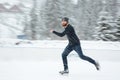 Handsome man ice skating outdoors Royalty Free Stock Photo