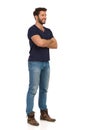 Handsome Man In Jeans, Boots And Blue T-shirt Is Standing With Arms Crossed And Smiling Royalty Free Stock Photo