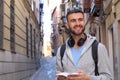 Handsome man joyfully exploring a city