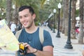 Handsome man joyfully exploring a city with copy space