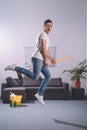 handsome man jumping with broom Royalty Free Stock Photo