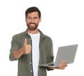 Handsome man with laptop showing thumb up gesture on white background Royalty Free Stock Photo
