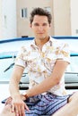 Handsome man with laptop sitting on white yacht