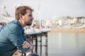 Handsome man leaning on a railing