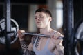 Handsome man lifting weights - a barbell - in a gym Royalty Free Stock Photo