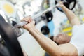 Handsome man lifting weights in gym Royalty Free Stock Photo