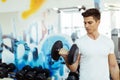 Handsome man lifting weights in gym Royalty Free Stock Photo