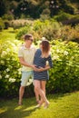 Handsome man is listening to his beautiful pregnant wife`s tummy and smiling Royalty Free Stock Photo