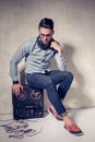 Handsome man listening to music on a magnetophone against grunge wall Royalty Free Stock Photo