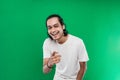 handsome man with long black hair Asian laughing happily while pointing at camera on