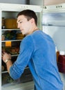 Handsome man looking for something in refrigerator Royalty Free Stock Photo