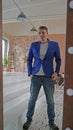 A handsome man looks in the mirror. A side view of a young man in a mirror in a modern bedroom Royalty Free Stock Photo
