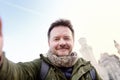 Handsome milddle age man making a self portrait selfie with famous royal castle Neuschwanstein on background