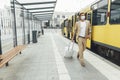 Handsome man in medical mask walking with suitcase outdoors Royalty Free Stock Photo