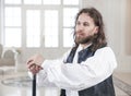 Handsome man in medieval clothes with cane Royalty Free Stock Photo