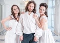 Handsome man in medieval costume and two woman in old-fashioned Royalty Free Stock Photo