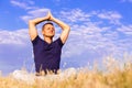 Handsome man meditating on the field.