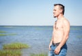 Handsome man with naked torso standing in the sea Royalty Free Stock Photo