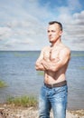 Handsome man with naked torso standing in the sea Royalty Free Stock Photo