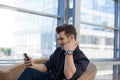 Joyful male leadership watching video on smartphone during work break Royalty Free Stock Photo