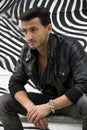 Handsome man outdoor in front of zebra striped graffiti