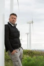 Handsome man. Outdoor male portrait over landscape with wind turbines Royalty Free Stock Photo