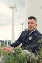 Handsome man. Outdoor male portrait over landscape with wind turbines Royalty Free Stock Photo