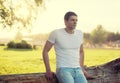 Handsome man outdoors, soft sunny sunset, man pensive Royalty Free Stock Photo