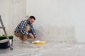 Handsome man painting wall with roller brush. Renovation house Royalty Free Stock Photo