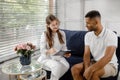 Handsome man patient have a discussion with the doctor therapist she showing the results for x-ray they discussing Royalty Free Stock Photo