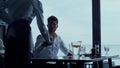 Handsome man paying lunch using smartphone nfc technology in stylish restaurant Royalty Free Stock Photo